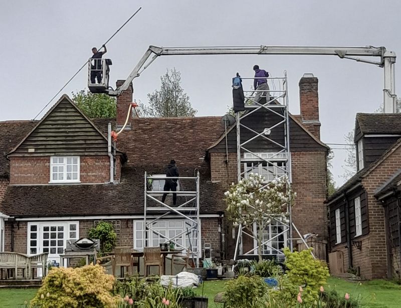 The Roof Moss Cleaners using cherry picker and scaffolding to clean roof safely and professionally in Histon, Cambridgeshire